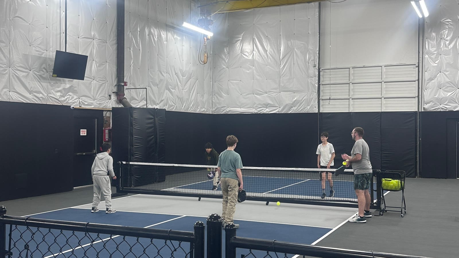 Kids and a coach on court for the Velocity Junior Program